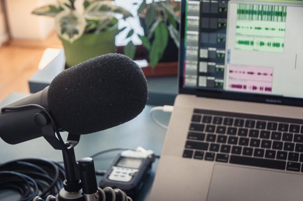 black microphone beside a macbook pro